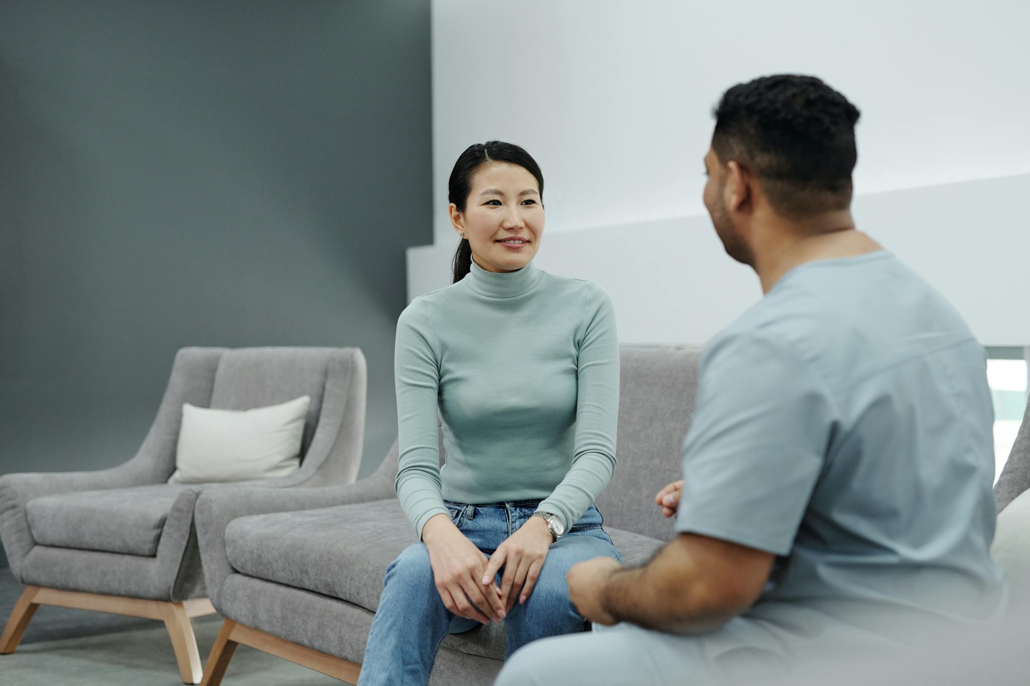 A doctor and patient having a friendly conversation in a modern clinic.