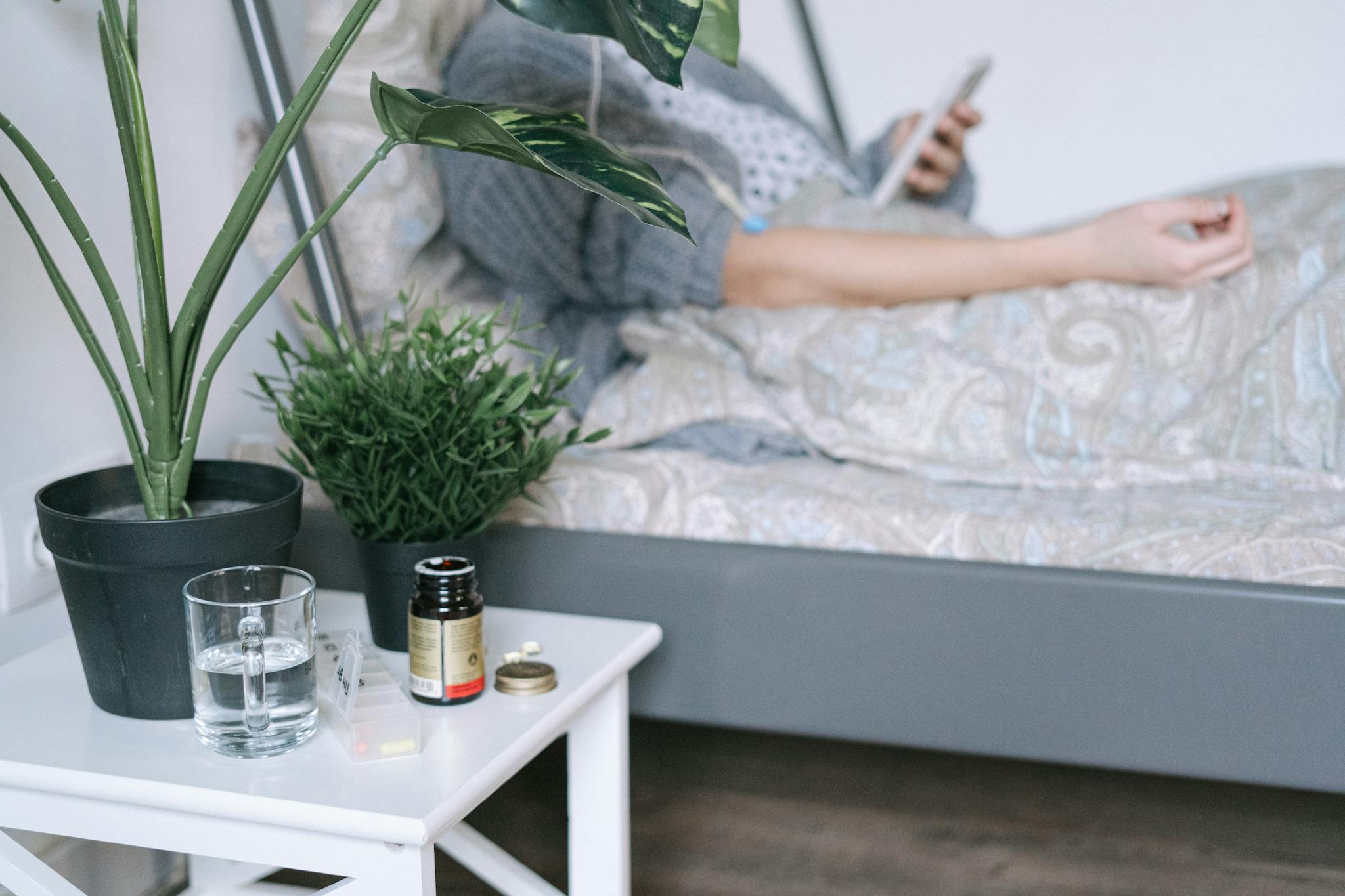 A patient resting in a hospital bed with care essentials nearby, illustrating a calm recovery environment.